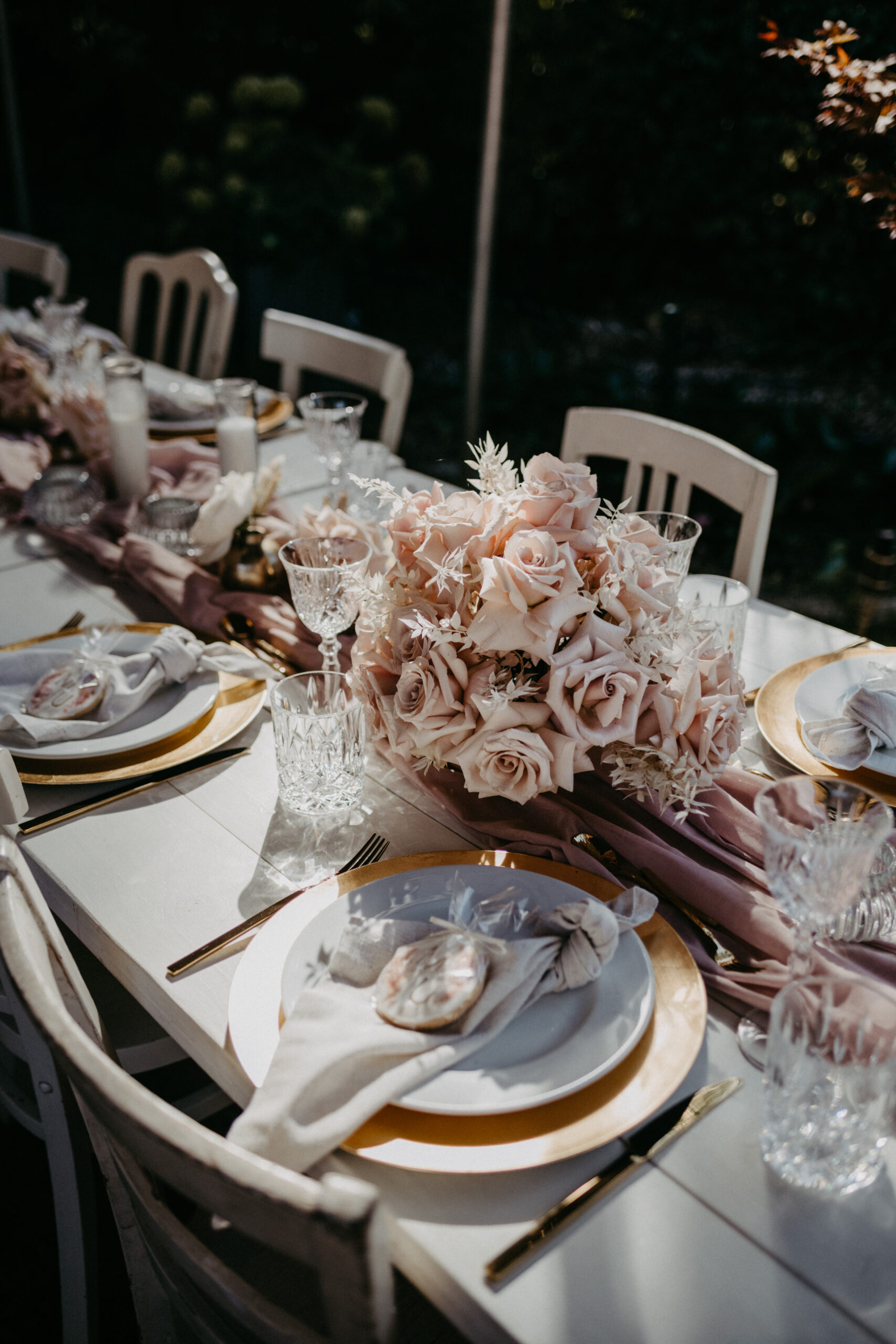Hochzeitstischdekoration , edel, mit rosa rose Rosen, Kristallgläsern und goldenen Elementen, dazu weiße Stühle, fotografiert von Daria Lanzet